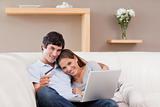 Happy couple booking vacations online