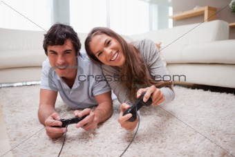 Couple playing video games on the floor
