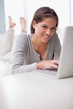Smiling woman chatting online on her couch