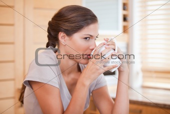 Side view of woman enjoying coffee