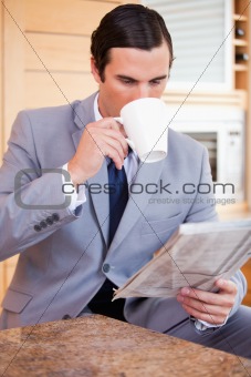 Businessman reading news and having a coffee