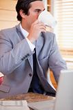 Businessman enjoying a cup of coffee in the kitchen