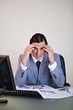 Frustrated businessman working on statistics