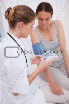 Doctor and patient measuring blood pressure