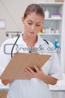 Doctor taking notes on clipboard