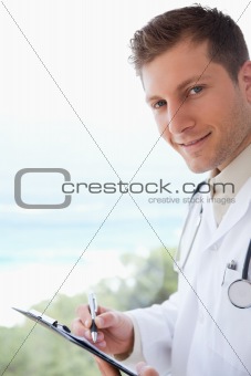 Side view of doctor with clipboard
