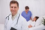 Doctor standing in patients room
