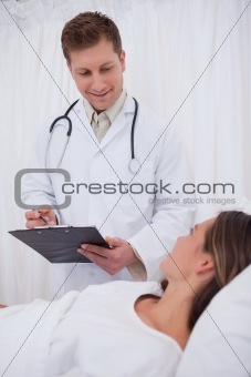 Doctor standing next to his patient