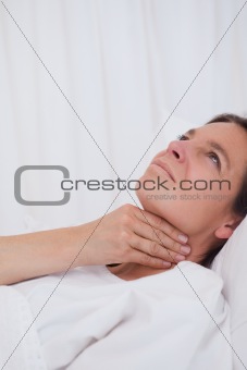 Woman rubbing her throat
