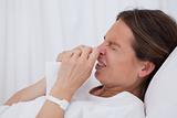 Side view of sneezing woman