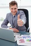 Happy businessman giving thumb up