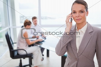 Consultant standing with cellphone