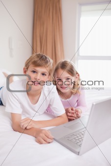 Portrait of children using a laptop