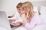 Smiling children using a laptop