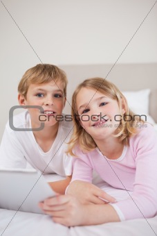 Portrait of children using a tablet computer