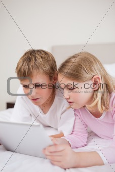 Portrait of cute children using a tablet computer