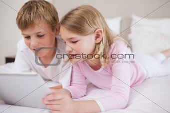Siblings using a tablet computer