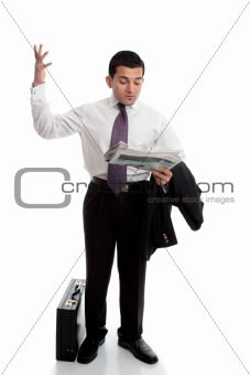 Businessman with newspaper throwing up hands