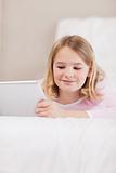 Portrait of a smiling little girl using a tablet computer