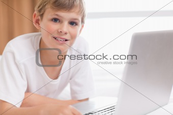 Smiling boy using a laptop