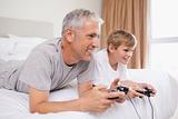 Happy father and his son playing video games