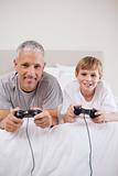 Portrait of a boy and his father playing video games