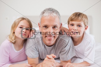Cute siblings and their father posing