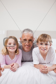 Portrait of siblings and their father posing