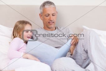 Father reading a story to his daughter