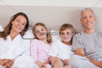 Family lying on a bed