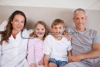 Happy family lying on a bed