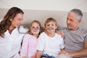Good looking family lying on a bed