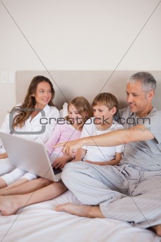 Portrait of a family using a notebook