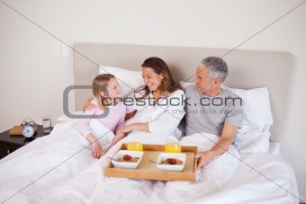 Girl having breakfast with her parents
