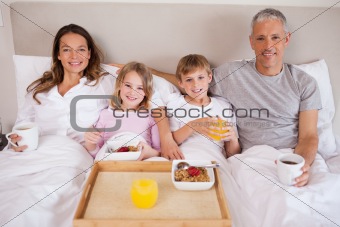Family having breakfast in a bedroom