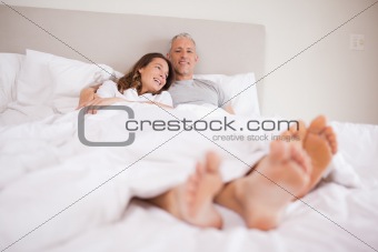 Charming couple lying in a bed