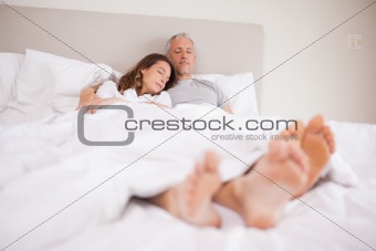 Couple sleeping in their bedroom