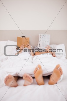 Portrait of playful couple reading