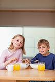 Portrait of young children having breakfast