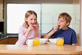 Children eating strawberries for breakfast