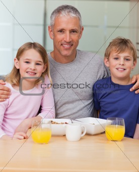 Portrait of a father posing with his children in the morning