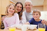 Close up of a smiling family having breakfast
