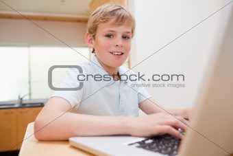 Blond boy using a notebook