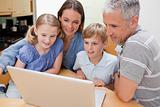 Lovely family using a laptop