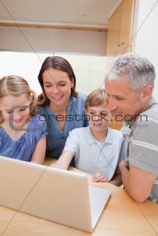 Portrait of a lovely family using a notebook