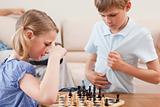 Siblings playing chess