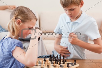 Siblings playing chess