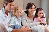 Cheerful family watching television together