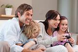 Delighted family playing video games together