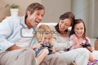 Laughing family playing video games